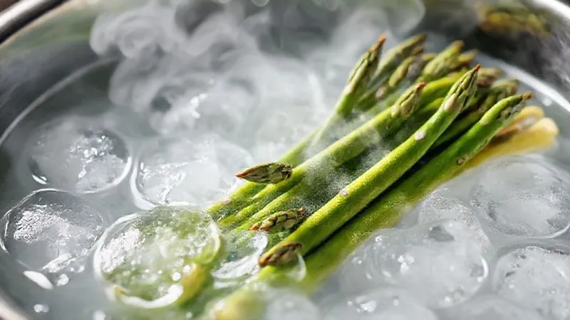 A professional photography shot of vibrant green asparagus being quickly blanched in boiling water, then immediately plunged into an ice bath, with steam gently rising from the hot water and crisp ice cubes visible in the cold water. Cinematic lighting, sharp focus on the asparagus, depth of field blurring the background. 8K hyper-detailed, shot on a high-end DSLR. A professional photography shot of vibrant green asparagus being quickly blanched in boiling water, then immediately plunged into an ice bath, with steam gently rising from the hot water and crisp ice cubes visible in the cold water. Cinematic lighting, sharp focus on the asparagus, depth of field blurring the background. 8K hyper-detailed, shot on a high-end DSLR.